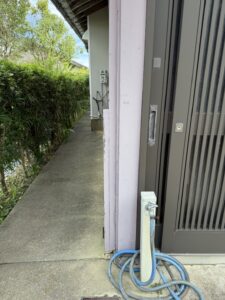 那智勝浦町下里の中古戸建の玄関まわりと立水栓、生垣沿いの通路